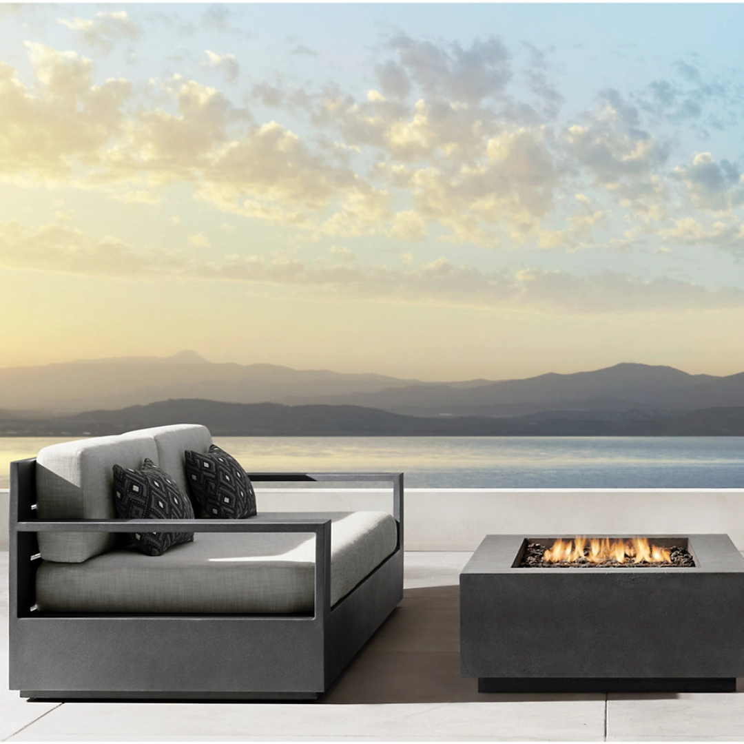 Luxury aluminium fire pit garden furniture set with cushions, black frame white cushions, image shows the sofa accompanied by the firepit