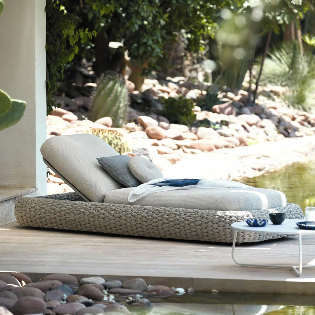 Modern White Garden Rattan Lounger for stylish outdoor seating, in a relaxed scenic background