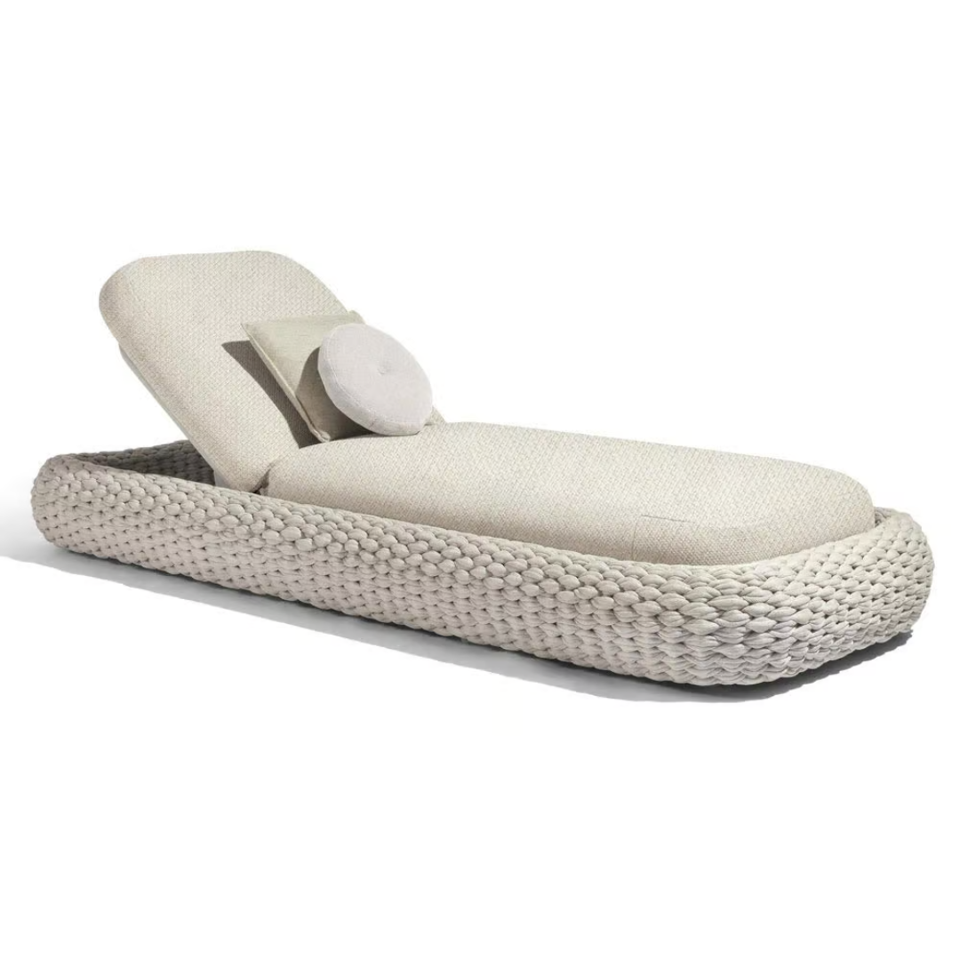 Contemporary outdoor lounger with sleek white rattan frame, with a white background