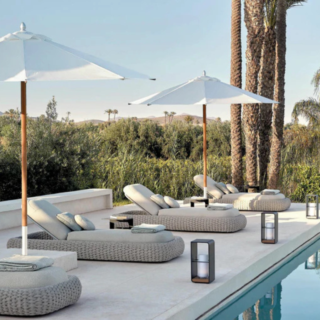 mulitple Contemporary outdoor lounger with sleek white rattan frame, with a poolside background