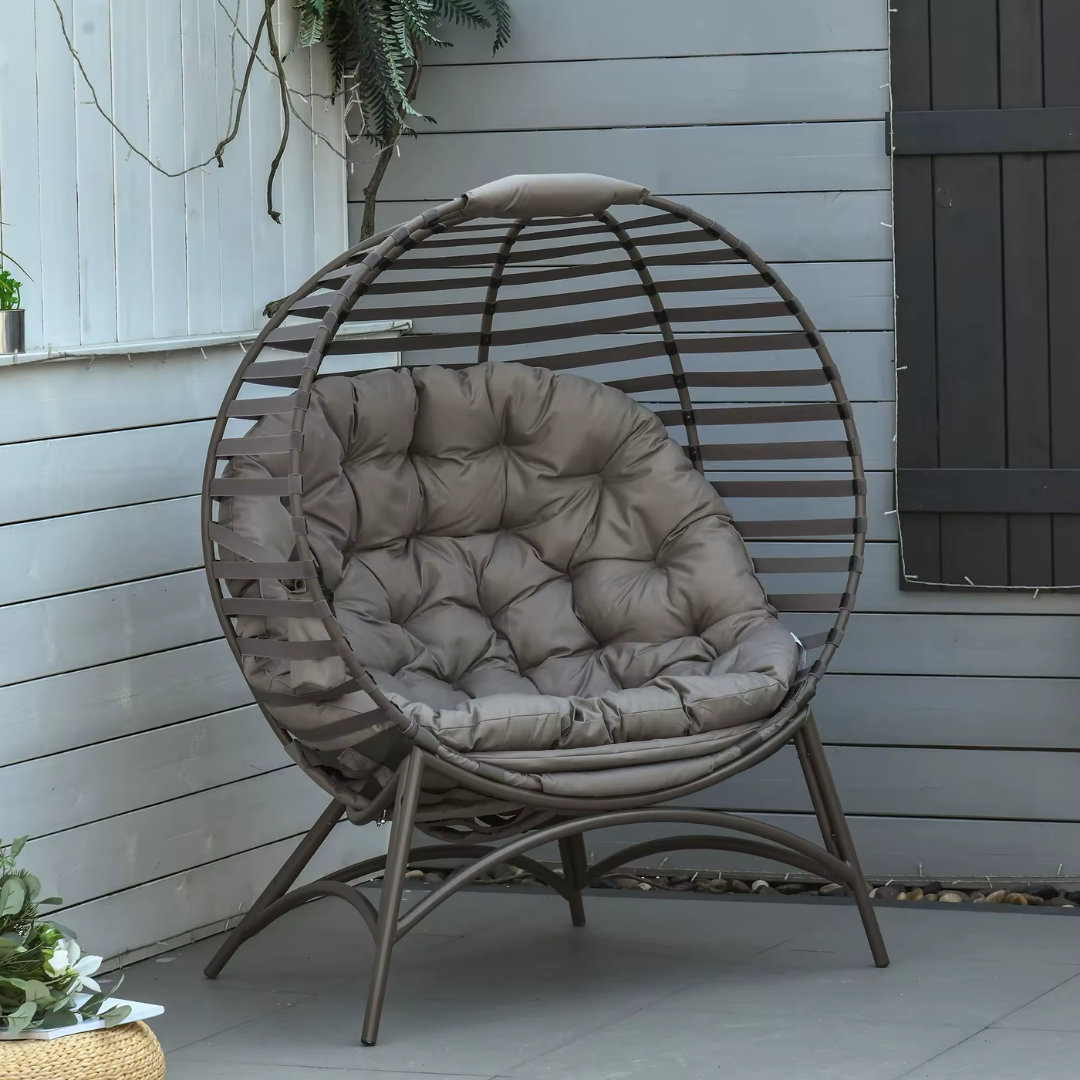 Standing basket style outdoor egg chair with cushion, set in a outdoor patio background