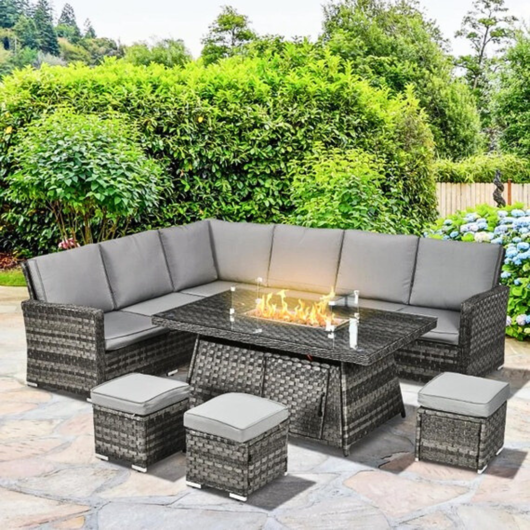 7 piece rattan fire pit garden furniture set, in a outdoor setting with the fire pit on.
