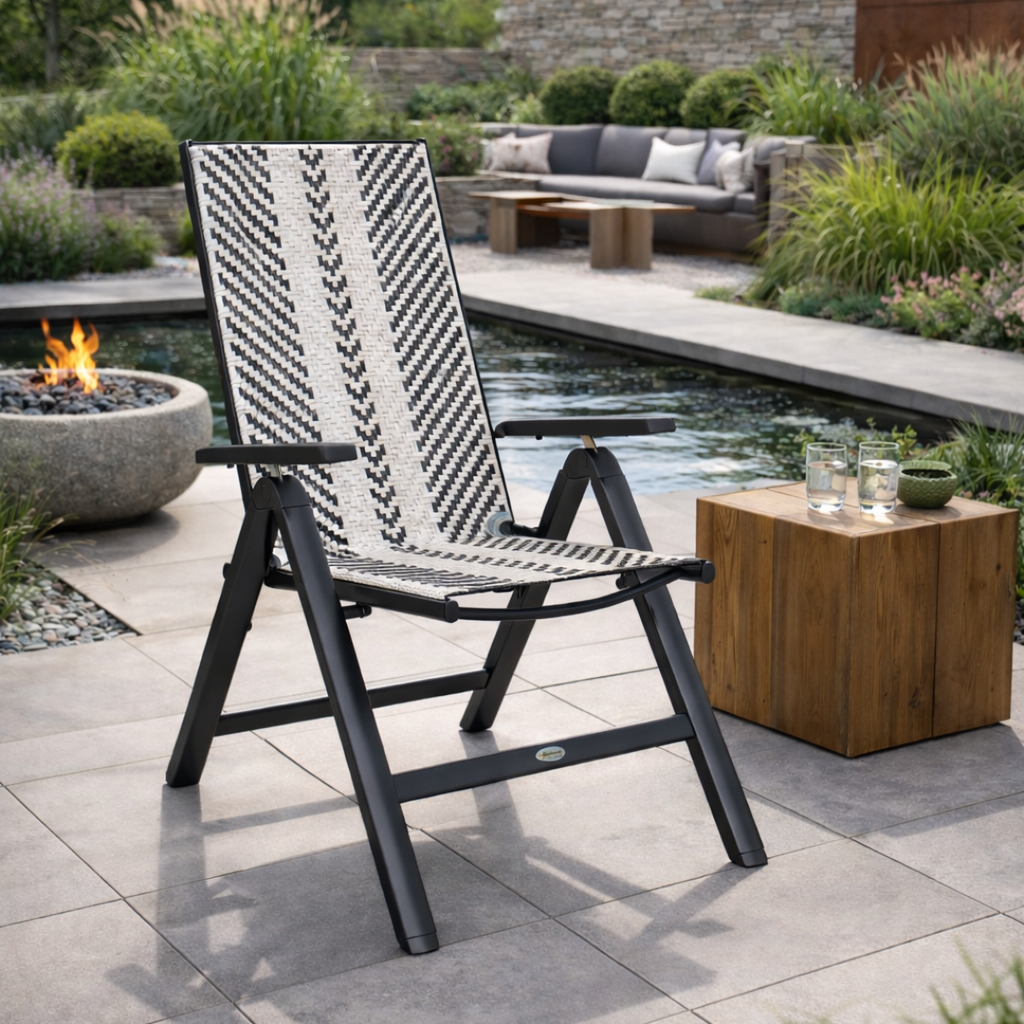 Black and white patterned chair on a patio with a pool and fire pit in the background