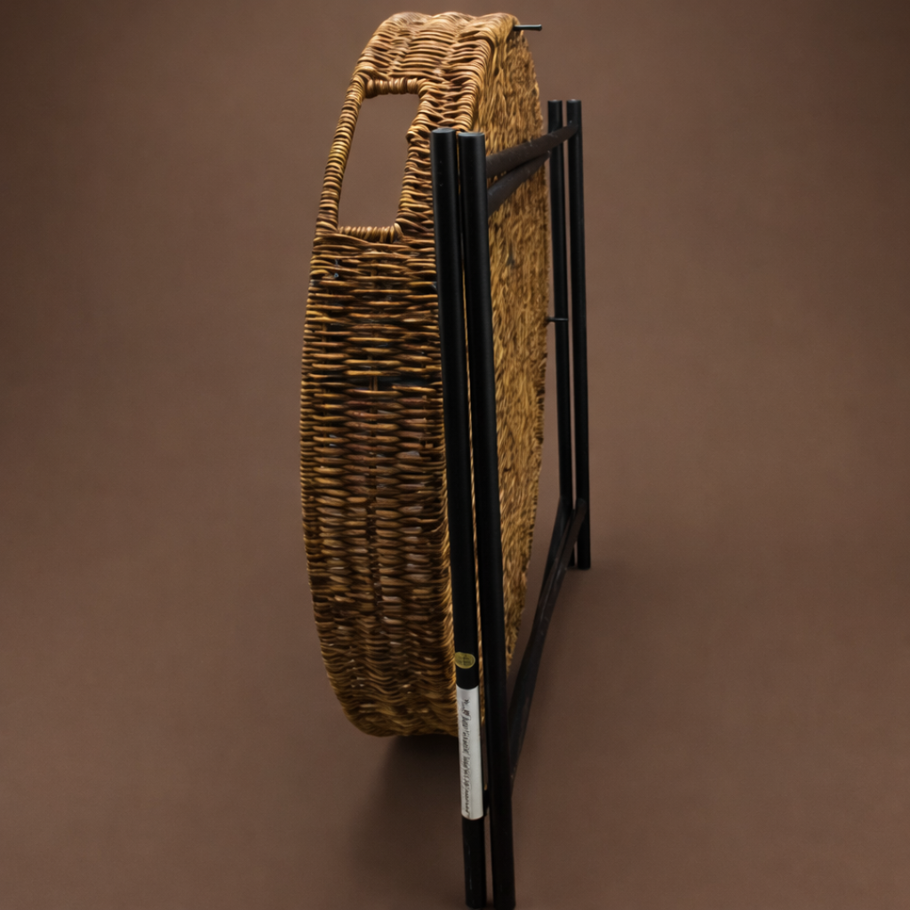 The image shows a wicker table folded down in a brown background.