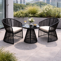 Black wicker outdoor furniture set with a small table and chairs on a patio.