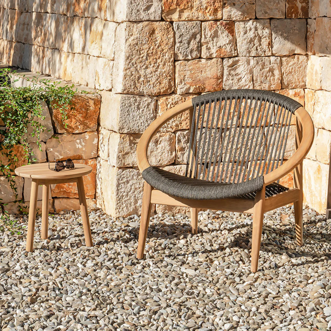 Black Contemporary Teak Garden Lounge Chair in a gravel garden