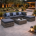 Outdoor patio furniture set with cushions on a stone patio, surrounded by garden lights and plants.