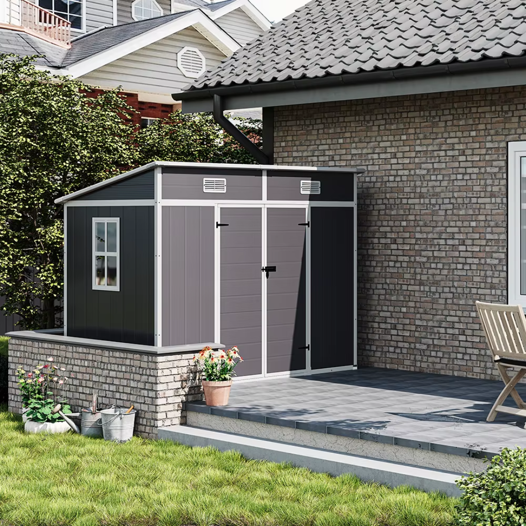 Low maintenance PVC garden shed with sloped roof, in a garden setting, resting on a garden patio.