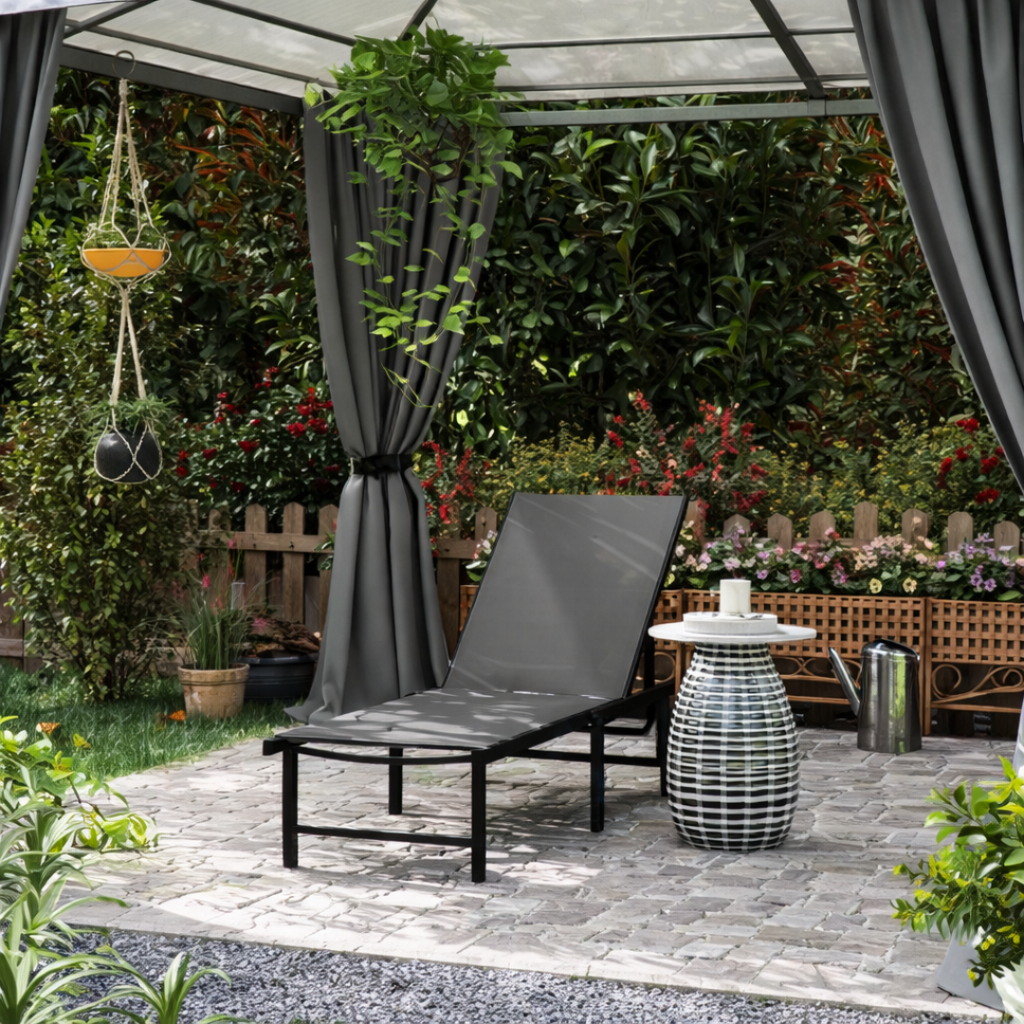 Outdoor patio with gray lounge chair, striped table, and greenery