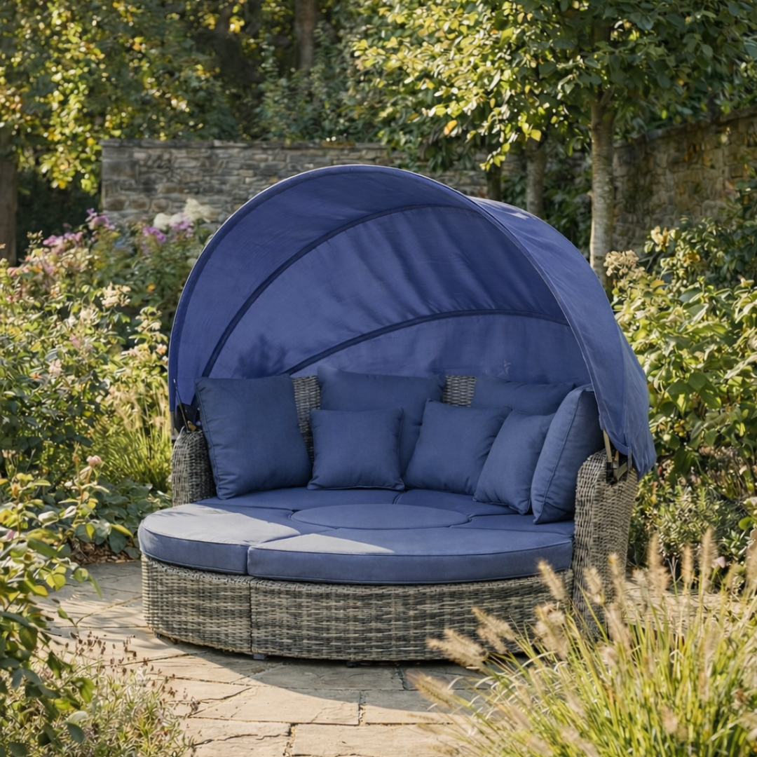 Blue outdoor canopy chair with cushions in a garden setting