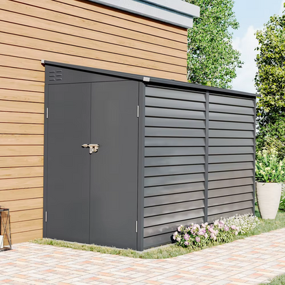 Lean-to black shed positioned against garden wall, image shows the shed leaning up against a house.