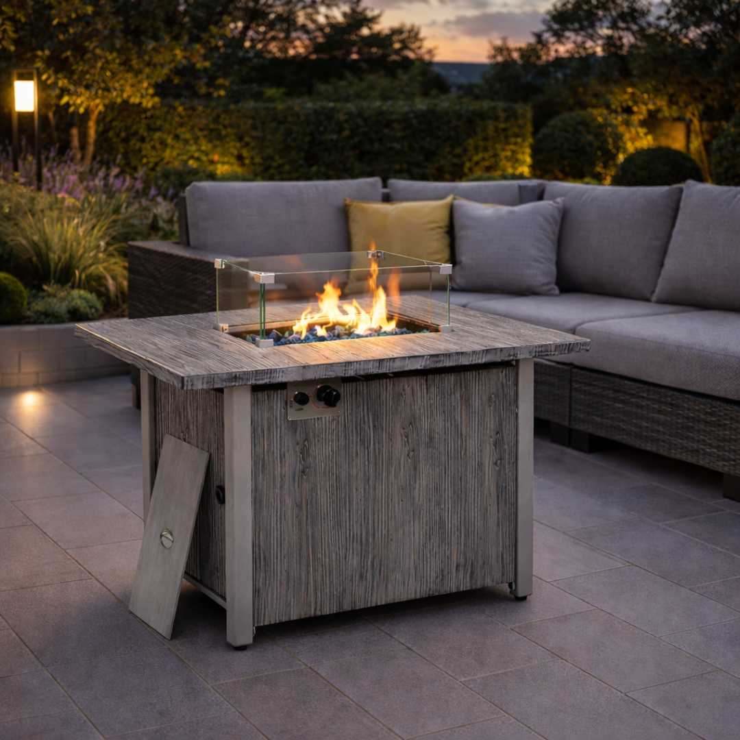 Rectangle fire pit dining table infront of modern sofa, set in a modern garden.