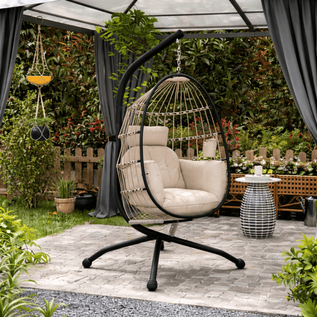 Outdoor egg hanging chair with stand, set in a tradition garden with greenery.