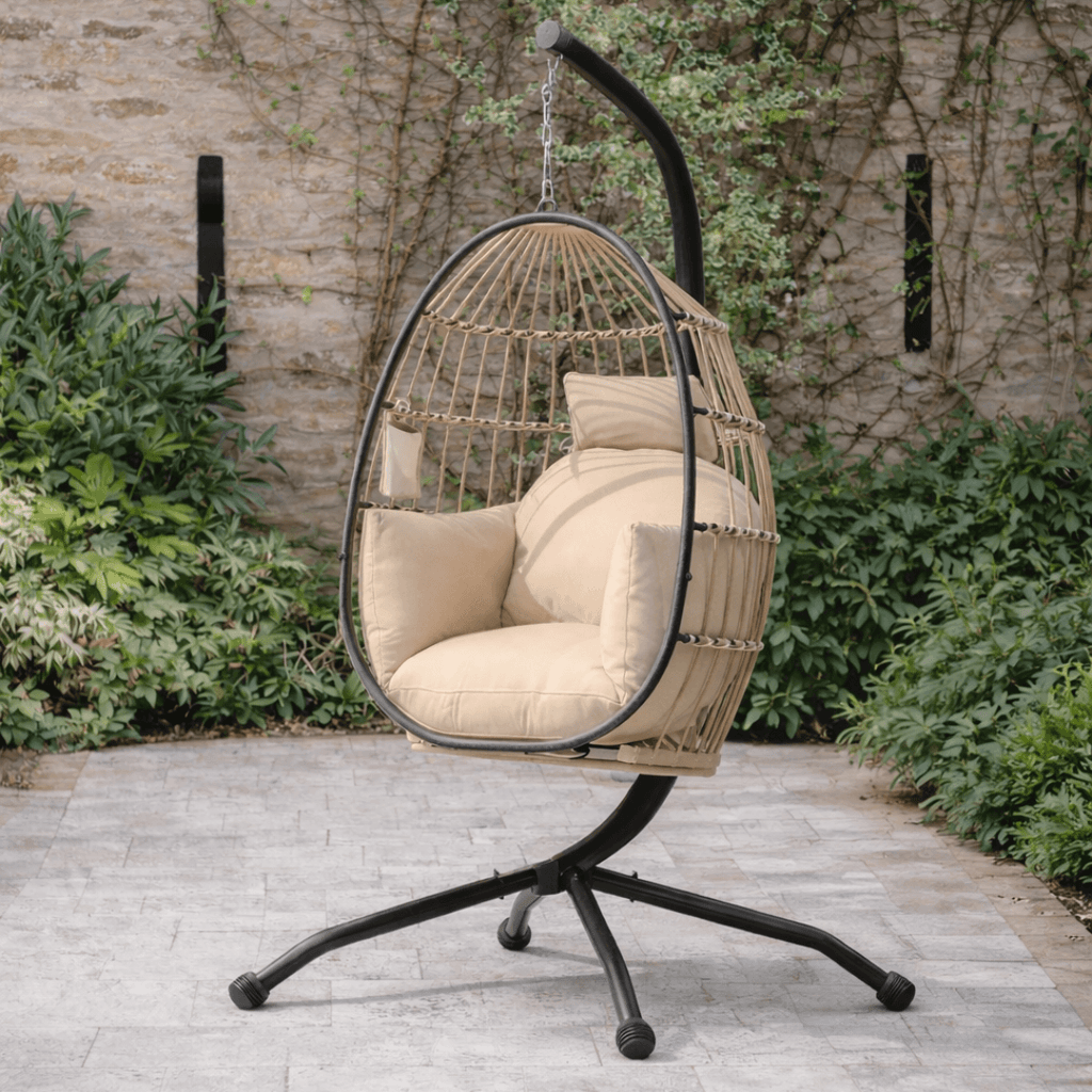 Modern beige hanging egg chair with metal frame, set in a modern outdoor patio.