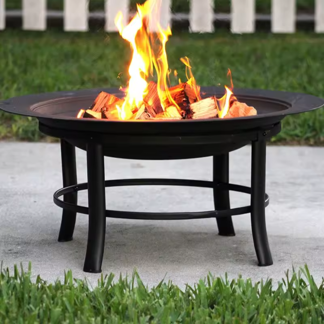 Metal fire bowl with clean circular design for garden, in a garden setting