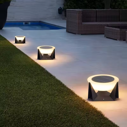"Round LED solar lamps for outdoor garden lighting, lighting up an outdoor footpath.