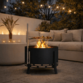 portable outdoor fire pit set in a contemporary garden in front of a sofa.
