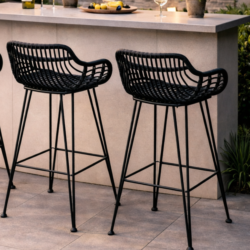 Pair of black wicker bar stools set in a modern outdoor bar.