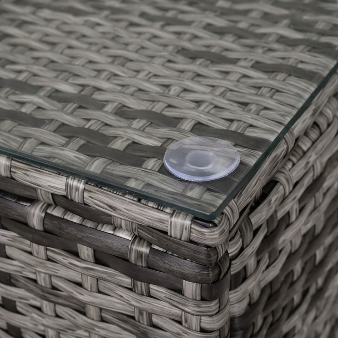 Glass table top with a clear suction cup on a woven rattan furniture piece.