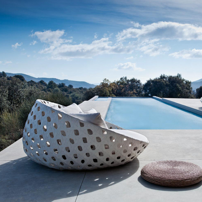 White Contemporary Woven Outdoor Round Daybed with plush cushions, in a scenic background